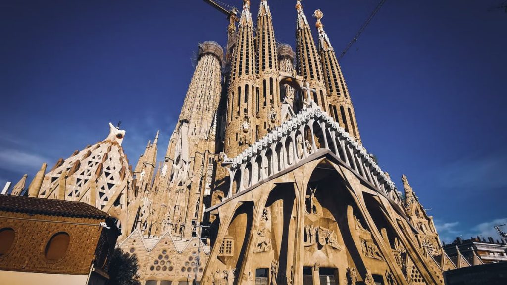 Striking low angle view of La Sagrada Familia, Barcelona's iconic basilica and UNESCO World Heritage Site.